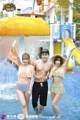 A man and two women standing next to each other in a water park.