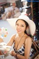 A woman in a white hat holding a bag of candy.